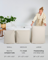 An image of a woman presenting small, medium, and large BADESOFA Back Bath Pillows in front of a white bathtub with dimensions and tub recommendations labeled below.